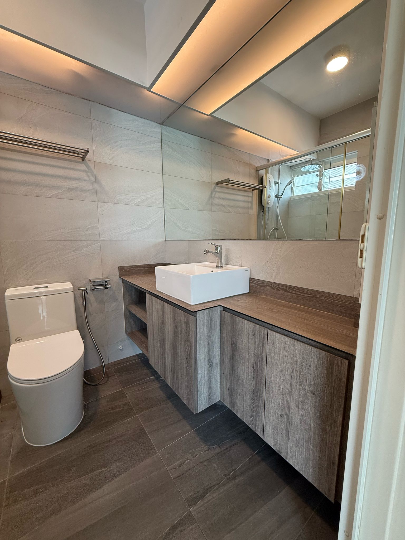 Contemporary HDB bathroom with wood-tone vanity, vessel basin, and stone-look wall tiles